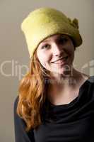 Smiling redhead with dimples in green hat