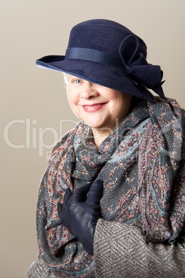 Smiling white-haired woman in hat and scarf
