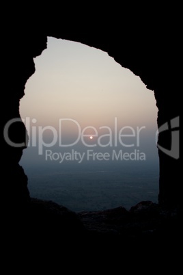 Sun on horizon in stone window