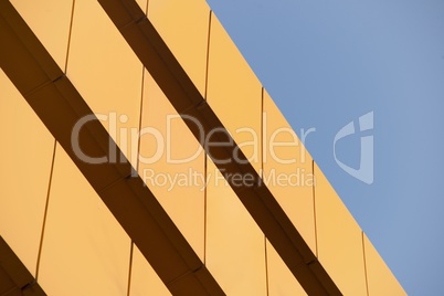 Wall of orange building against blue sky