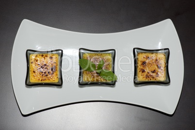 Plate of three creme brulees from above