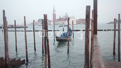 Venetian gondolas tied near the pier on San Marco square, Venice, Italy