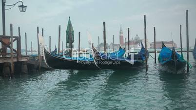 Venetian gondolas tied near the pier on San Marco square, Venice, Italy