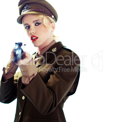 Glamorous army officer aiming a rifle