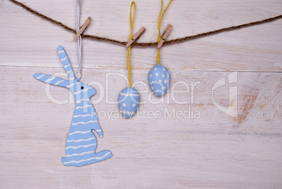 Blue Easter Bunny And Easter Eggs Hanging On Line