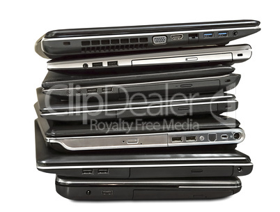 stack of old laptops awaiting repair isolated on white backgroun