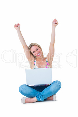 Pretty blonde cheering and having laptop