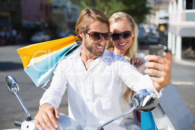 Attractive couple riding a scooter