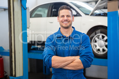 Smiling mechanic looking at camera