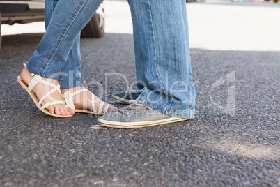 Cute couple standing wearing jeans