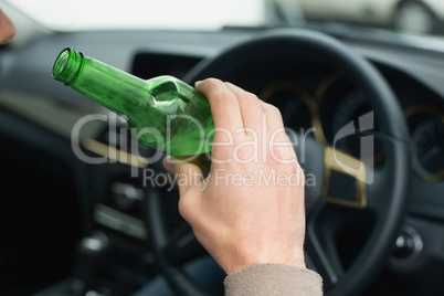 Man drinking beer while driving