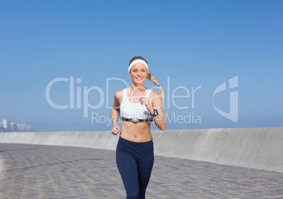 Fit blonde jogging on the pier