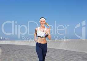 Fit blonde jogging on the pier