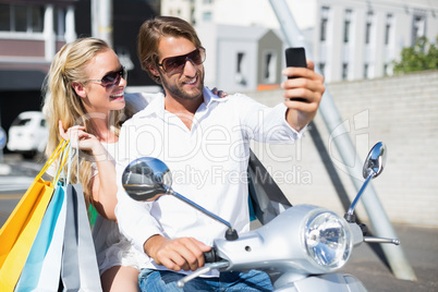 Attractive couple riding a scooter