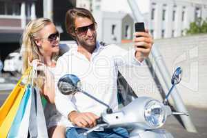 Attractive couple riding a scooter