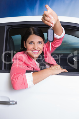 Smiling woman holding car key