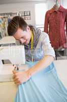 Smiling student using sewing machine