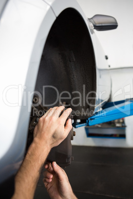 Focused mechanic adjusting the wheel