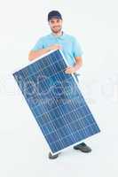 Smiling construction worker holding solar panel