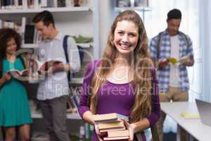 Student carrying small pile of books