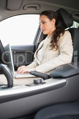 Businesswoman working in the drivers seat