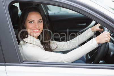 Pretty woman smiling and driving