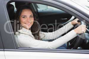 Pretty woman smiling and driving