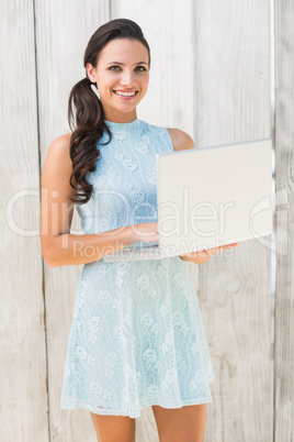 Stylish brunette using a laptop