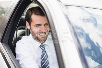 Happy businessman in the drivers seat