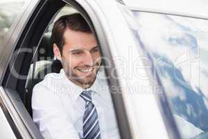 Happy businessman in the drivers seat