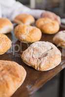 Close up of baker showing tray of rolls