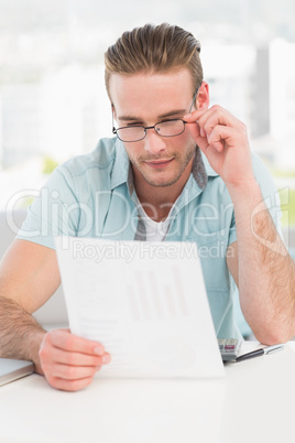 Businessman reading document at his desk