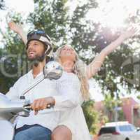 Cute couple riding a scooter