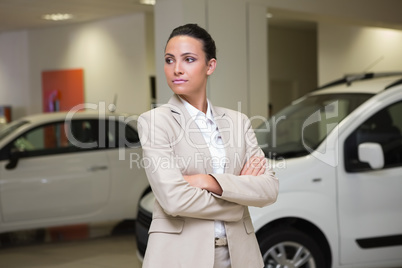 Focused businessman standing with arms crossed