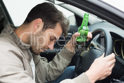 Man drinking beer while driving