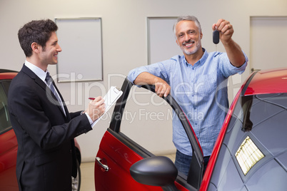 Smiling customer showing his new key