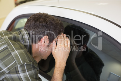 Man looking inside a car