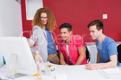 Smiling students working together on computer