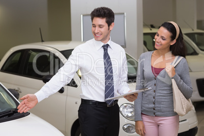 Businessman showing a car to a woman Businessman showing a car to a woman