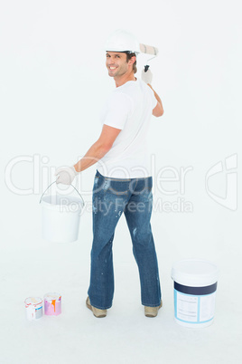 Happy man using paint roller