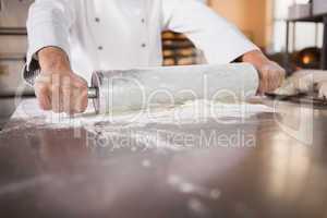 Close up of baker using a rolling pin