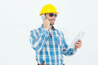 Carpenter using digital tablet and cellphone