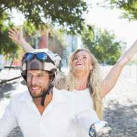 Attractive couple riding a scooter