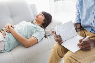Therapist listening his colleague and taking notes