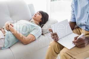 Therapist listening his colleague and taking notes