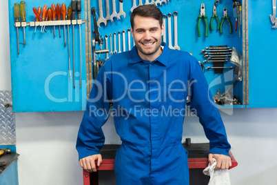 Smiling mechanic looking at camera