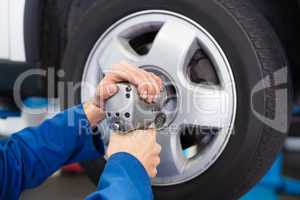 Mechanic adjusting the tire wheel