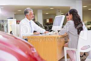 Salesman speaking with a smiling couple