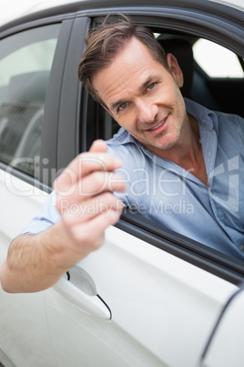 Handsome man smiling and holding key