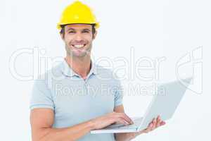 Carpenter using laptop  over white background